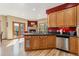Open kitchen has stone fireplace, stainless appliances, granite counters, and access to outdoor deck at 278 Snowshoe Cir, Breckenridge, CO 80424