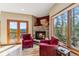 A cozy living room featuring a stone fireplace, wood floors, and French doors leading to the deck at 278 Snowshoe Cir, Breckenridge, CO 80424