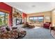 Charming living room features a stone fireplace, plush seating, and expansive windows with scenic views at 278 Snowshoe Cir, Breckenridge, CO 80424
