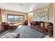 Bright living room boasts oversized windows with mountain views, comfortable seating, and an open layout at 278 Snowshoe Cir, Breckenridge, CO 80424