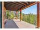 Spacious patio with beautiful views of the surrounding forest and a glimpse of a shed at 278 Snowshoe Cir, Breckenridge, CO 80424