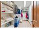 Spacious walk-in closet with shelving for clothing and storage with carpeted floor and overhead lighting at 278 Snowshoe Cir, Breckenridge, CO 80424
