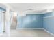 Large basement space with blue walls, carpet, and stairs to the main floor at 4821 W 102Nd Ave, Westminster, CO 80031
