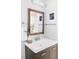 Stylish bathroom featuring a modern vanity with a copper-framed mirror and decorative greenery at 4821 W 102Nd Ave, Westminster, CO 80031