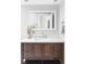 Bathroom features a dark wooden vanity with white countertop and decorative mirror at 4821 W 102Nd Ave, Westminster, CO 80031