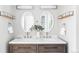 Elegant bathroom features a dual sink vanity with framed mirrors and modern fixtures at 4821 W 102Nd Ave, Westminster, CO 80031
