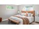 Comfortable bedroom with neutral colors, a wooden bench, and ample natural light at 4821 W 102Nd Ave, Westminster, CO 80031