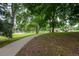Community park featuring a playground, benches, and a paved walking path through the green space at 4821 W 102Nd Ave, Westminster, CO 80031