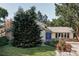 Charming home featuring a blue front door, stone accents, mature trees and flowering shrubs at 4821 W 102Nd Ave, Westminster, CO 80031