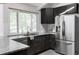 Modern kitchen featuring dark cabinets, stainless steel appliances and a beautiful granite countertop at 4821 W 102Nd Ave, Westminster, CO 80031