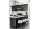 Kitchen island with granite countertops, modern pendant lighting, dark cabinetry, and stainless steel microwave at 4821 W 102Nd Ave, Westminster, CO 80031