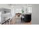 Open concept living area with kitchen island, dining area, and comfortable seating on hardwood floors at 4821 W 102Nd Ave, Westminster, CO 80031