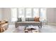 Bright living room with a comfortable gray sofa, decorative pillows, a stylish coffee table, and a large window at 4821 W 102Nd Ave, Westminster, CO 80031