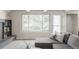 Relaxing living room with gray sofa, brick fireplace, large window and an outside view at 4821 W 102Nd Ave, Westminster, CO 80031