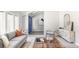 Inviting living room featuring a modern sofa, stylish decor, bright lighting, and an eye-catching blue front door at 4821 W 102Nd Ave, Westminster, CO 80031