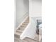 Carpeted staircase with white railing and a landing halfway to the second floor at 4821 W 102Nd Ave, Westminster, CO 80031