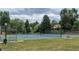 A fenced-in community tennis court with well-maintained blue surface and views of the surrounding neighborhood at 4821 W 102Nd Ave, Westminster, CO 80031
