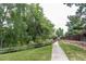 Sidewalk along a green space with a creek and split rail fence next to a residential area at 4821 W 102Nd Ave, Westminster, CO 80031