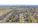 Aerial view of a neighborhood showcasing single Gathering homes, tree lined streets, and nearby schools at 23298 Barnsley Ln, Parker, CO 80138