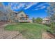 Backyard of the home features a lawn, wood deck, privacy fence, and mature trees at 23298 Barnsley Ln, Parker, CO 80138