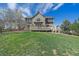 A backyard featuring a wooden deck, lawn, and mature trees create a private outdoor space at 23298 Barnsley Ln, Parker, CO 80138