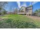 The home features a large backyard with a wooden deck, lawn, and privacy fence at 23298 Barnsley Ln, Parker, CO 80138