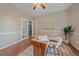 Well-lit bedroom showcasing a warm wooden desk, complemented by neutral decor and plenty of natural light at 23298 Barnsley Ln, Parker, CO 80138