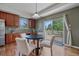 Cozy dining area with a round table and chairs, adjacent to a sliding glass door to the deck at 23298 Barnsley Ln, Parker, CO 80138