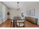 Dining room featuring hardwood floors, light fixture, and view to kitchen at 23298 Barnsley Ln, Parker, CO 80138