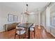 Spacious dining room featuring hardwood floors, light fixture, and bright lighting at 23298 Barnsley Ln, Parker, CO 80138