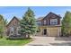 Beautiful two-story home with a well-manicured lawn and mature landscaping at 23298 Barnsley Ln, Parker, CO 80138