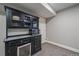 Basement kitchenette features a built-in cabinet, microwave, and countertop space, perfect for entertaining guests at 23298 Barnsley Ln, Parker, CO 80138