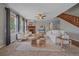 Bright living room with a fireplace, large windows, and neutral decor at 23298 Barnsley Ln, Parker, CO 80138