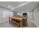 Basement living room offers an entertainment area with a large sofa and a stylish high-top table with barstool seating at 23298 Barnsley Ln, Parker, CO 80138