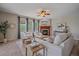 Bright living room with a fireplace, large windows, and neutral decor at 23298 Barnsley Ln, Parker, CO 80138