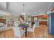 Open concept living space with a dining area, fireplace, and view into the kitchen at 23298 Barnsley Ln, Parker, CO 80138