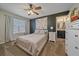 Cozy main bedroom features a ceiling fan, bedside table, and ensuite bathroom for ultimate comfort and convenience at 23298 Barnsley Ln, Parker, CO 80138