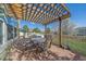 Outdoor patio seating area with a pergola offering shade for dining and relaxing at 23298 Barnsley Ln, Parker, CO 80138