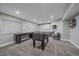 Basement recreation room with a foosball table, shuffleboard table, and a cozy lounge area with a fireplace at 23298 Barnsley Ln, Parker, CO 80138