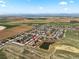 Aerial view of a neighborhood, with a pond and surrounding farmland at 2757 Stallion Way, Mead, CO 80542