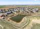 Scenic aerial view of a neighborhood with a pond and mountain views at 2757 Stallion Way, Mead, CO 80542