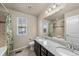 A well-lit bathroom featuring dual sinks, granite countertops, and a shower/tub combo at 2757 Stallion Way, Mead, CO 80542