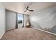 This bedroom features a modern ceiling fan, light gray walls, neutral carpet, and a mountain graphic at 2757 Stallion Way, Mead, CO 80542