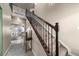 Bright foyer with staircase featuring wood railing and carpeted steps at 2757 Stallion Way, Mead, CO 80542