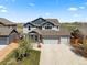 Charming two-story home boasts a manicured lawn and an attached two-car garage at 2757 Stallion Way, Mead, CO 80542