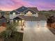 Charming two-story home with a three-car garage, lush lawn, and colorful sky at 2757 Stallion Way, Mead, CO 80542