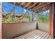 Wood balcony offering a lovely view of trees and nearby buildings at 3050 W 32Nd Ave # 104C, Denver, CO 80211