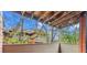 Relaxing balcony view with exposed wood beam ceiling and string lights overlooking mature trees at 3050 W 32Nd Ave # 104C, Denver, CO 80211