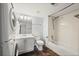 Full bathroom with vanity, toilet, and tiled shower-tub combination; washer and dryer in bathroom at 3050 W 32Nd Ave # 104C, Denver, CO 80211