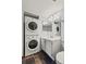Well-lit bathroom with stackable washer/dryer, vanity with marble countertop, and mirrored medicine cabinet at 3050 W 32Nd Ave # 104C, Denver, CO 80211